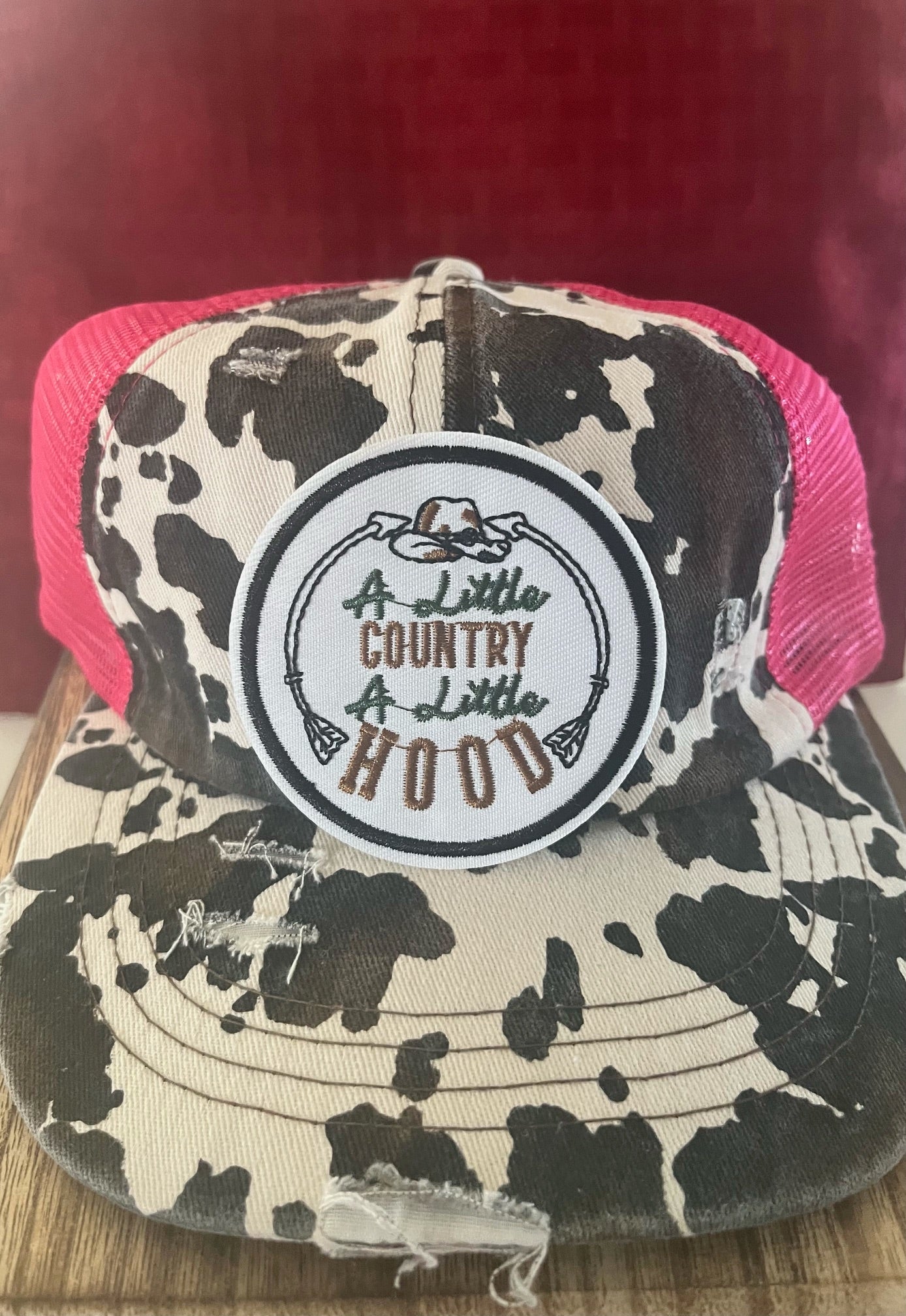 A LITTLE COUNTRY AND A LITTLE HOOD PINK COW PRINT -TRUCKER HAT