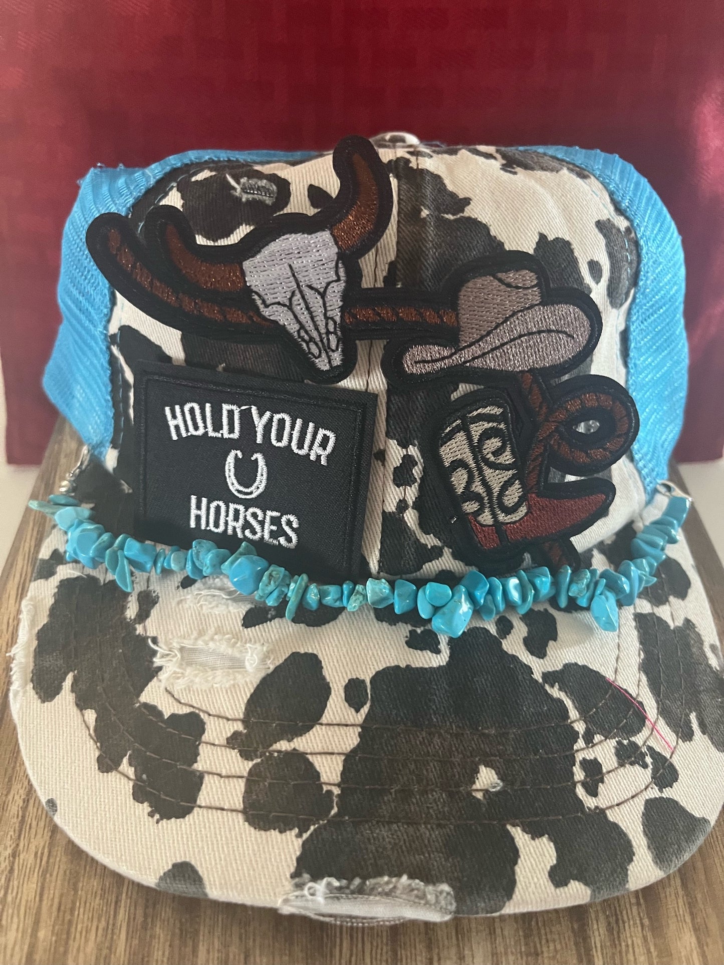 HOLD YOUR HORSE TEAL COW PRINT -TRUCKER HAT